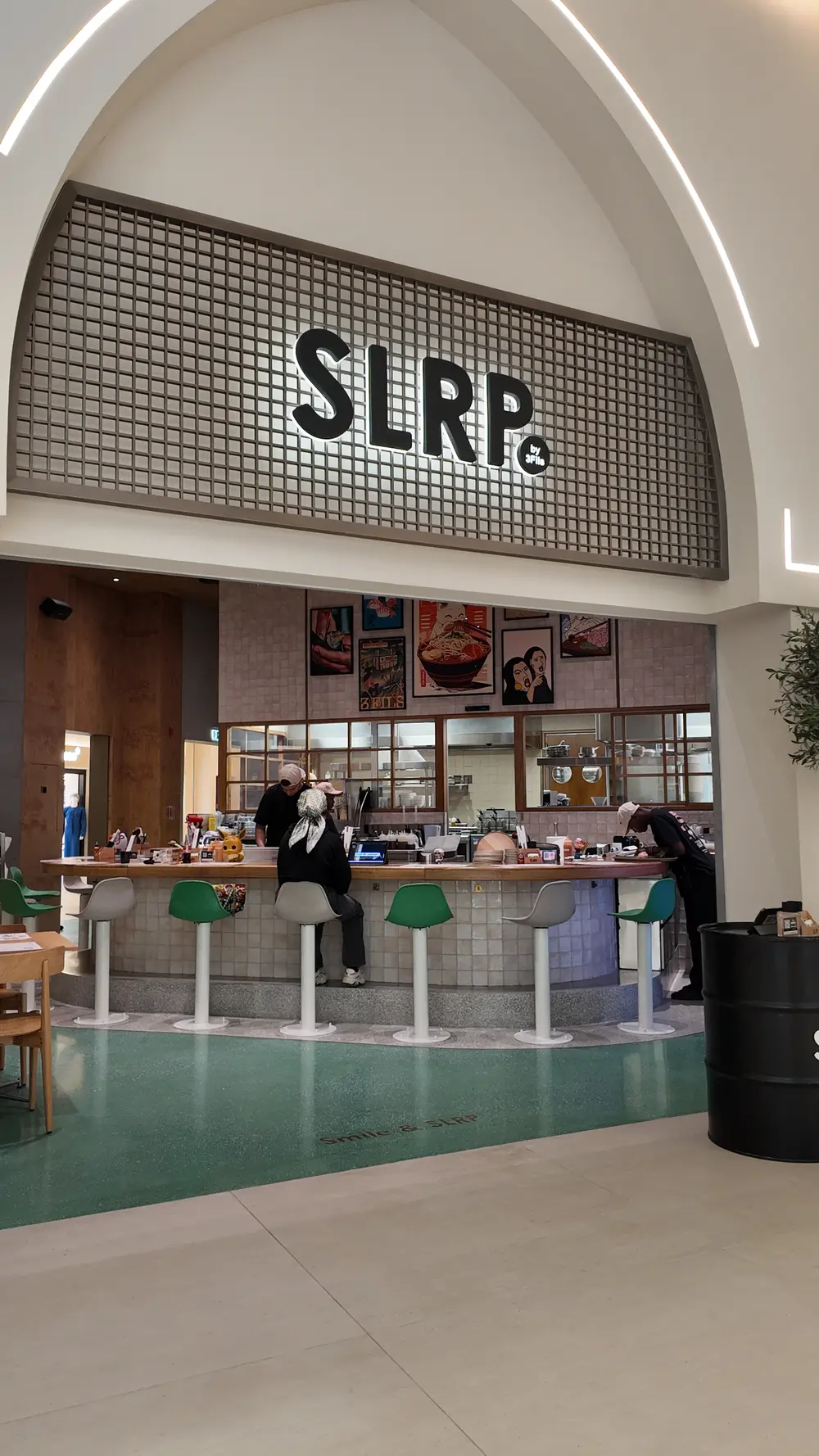 [OUT] Modern Japanese ramen restaurant interior with sleek wooden countertops, minimalist decor, and ambient lighting in Dubai, UAE. [/OUT]